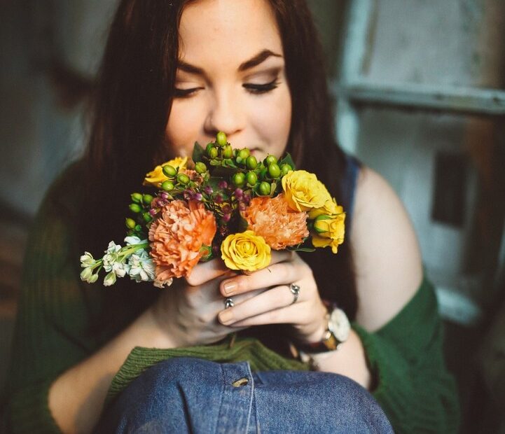 woman smelling flowers